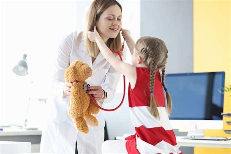 Premium Photo Pediatrician Doctor And Little Girl Are Holding Pig Premium Photo Pediatrician Doctor And Little Girl Are Holding Pig